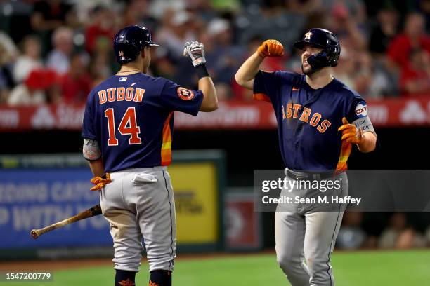 Mauricio Dubon congratulates Chas McCormick of the Houston Astros after his solo homerun during the eighth inning of a game against the Los Angeles...