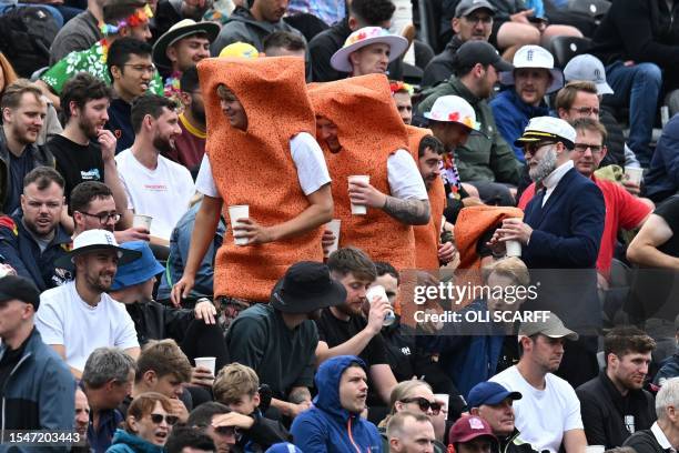 Spectators in fancy dress in the crowd on day four of the fourth Ashes cricket Test match between England and Australia at Old Trafford cricket...