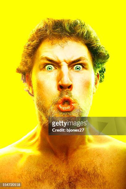 young man making crazy face on yellow background - bitter stock pictures, royalty-free photos & images
