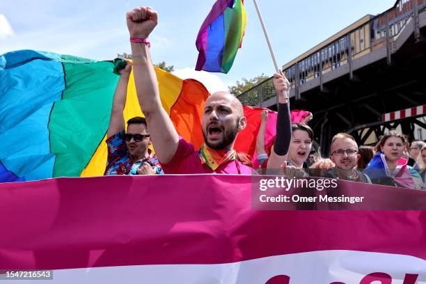 Participants cheer with pride rainbow flags during the annual Christopher Street Day parade on July 22, 2023 in Berlin, Germany. CSD Berlin is among...