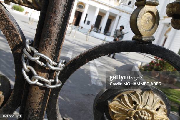 An Egyptian soldier guards the Parliament building as anti-government protesters stage a sit-in outside, some 500 meters from Cairo's Tahrir Square,...