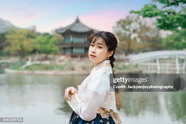 tourists dressed in hanbok korea traditional attire visit gyeongbokgung palace to learn history and relax in seoul. korea, south. - gyeongbokgung palace stock pictures, royalty-free photos & images