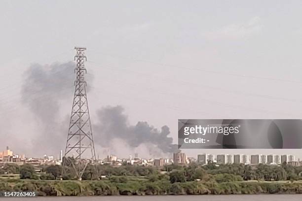 Picture taken from Omdurman shows smoke billowing north of Khartoum on July 22, 2023.