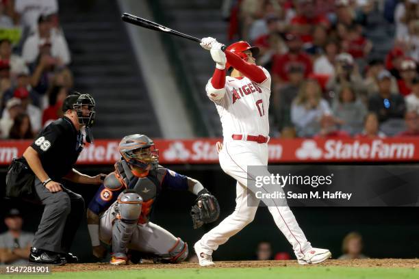 Shohei Ohtani of the Los Angeles Angels connects for a solo homerun during the ninth inning of a game against the Houston Astros at Angel Stadium of...