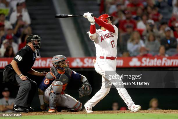 Shohei Ohtani of the Los Angeles Angels connects for a solo homerun during the ninth inning of a game against the Houston Astros at Angel Stadium of...