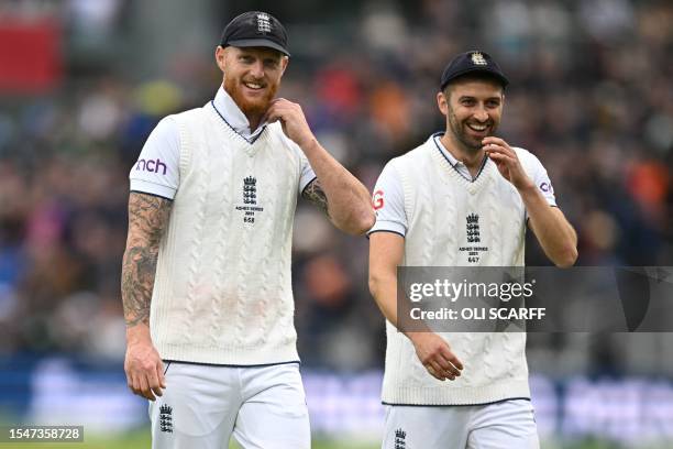 England's captain Ben Stokes and England's Mark Wood share a joke as they leave at the tea break on day four of the fourth Ashes cricket Test match...