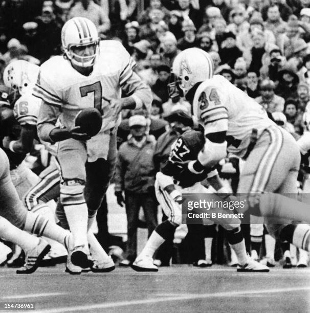 Quaterback Dan Pastorini of the Houston Oilers hands the ball off to running back Earl Campbell during the 2nd quarter of their Semi-Final Playoff...