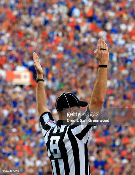 Referee signals a touchdown during the game between the Florida Gators and the LSU Tigers at Ben Hill Griffin Stadium on October 6, 2012 in...