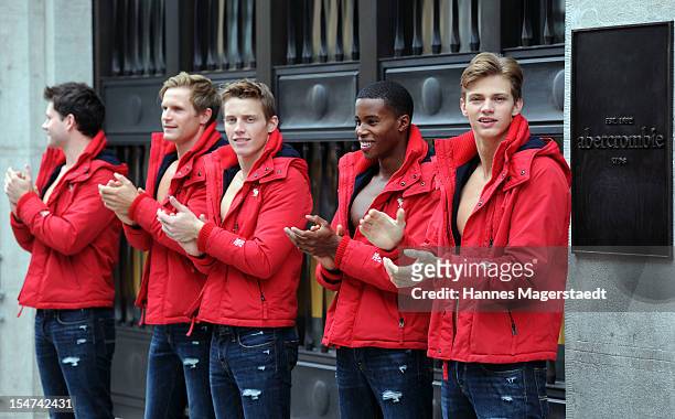 Male models pose outside the Abercrombie & Fitch flagship clothing store before the opening of Abercrombie & Fitch Munich flagship store on October...