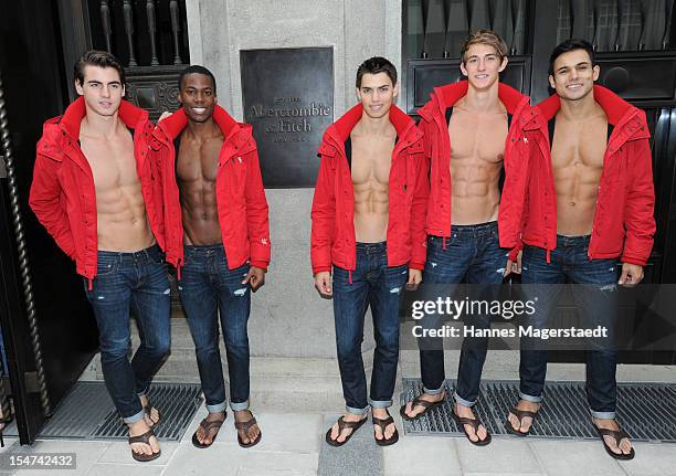 Male models pose outside the Abercrombie & Fitch flagship clothing store before the opening of Abercrombie & Fitch Munich flagship store on October...