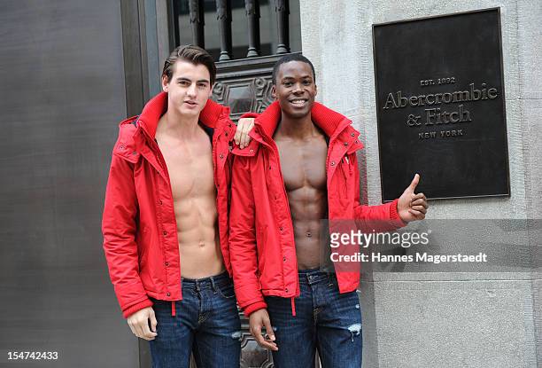 Male models pose outside the Abercrombie & Fitch flagship clothing store before the opening of Abercrombie & Fitch Munich flagship store on October...