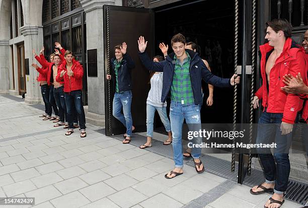 Models open the door during Abercrombie & Fitch flagship store opening on October 25, 2012 in Munich, Germany.