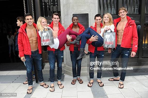 Young women pose for photographs with male models outside the Abercrombie & Fitch flagship clothing store during the opening of Abercrombie & Fitch...