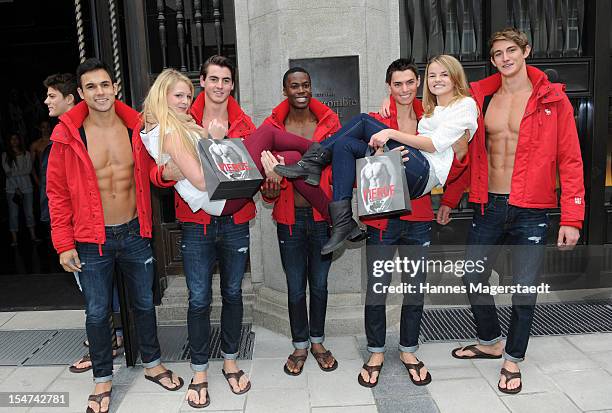 Young women pose for photographs with male models outside the Abercrombie & Fitch flagship clothing store during the opening of Abercrombie & Fitch...