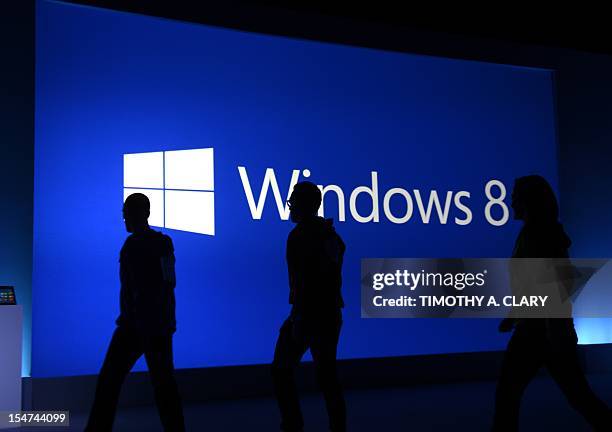 Staffers walk on the stage following a press conference at Pier 57 to officially launch Windows 8 in New York October 25, 2012. Microsoft said...