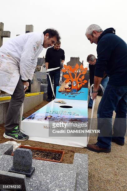 Workers install the "iron grave" of the family of Serge Danot who died in 1990 and was the creator of the French television programme "The Magic...