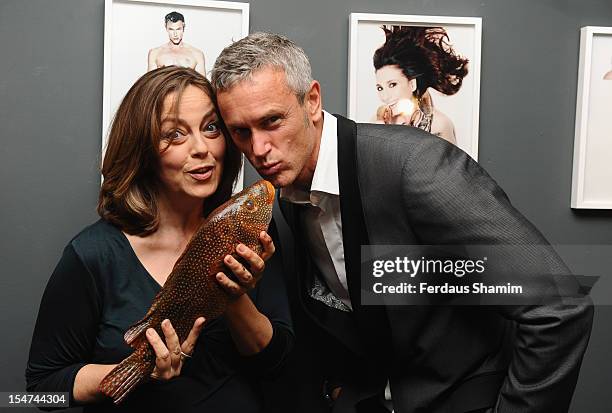 Greta Scacchi and Mark Foter attend a photocall ahead of the private view of Rankin: Fishlove on October 25, 2012 in London, England.