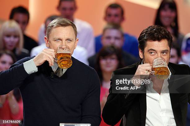 British actor Daniel Craig and Spanish actor Javier Bardem, starring in the new James Bond film "Skyfall", drink glasses of beer as they take part in...