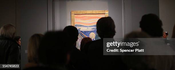 People look at Edvard Munch's "The Scream," which went on display in Manhattan's Museum of Modern Art for a six-month exhibition October 25, 2012 in...