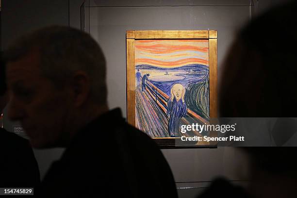 People look at Edvard Munch's "The Scream," which went on display in Manhattan's Museum of Modern Art for a six-month exhibition October 25, 2012 in...