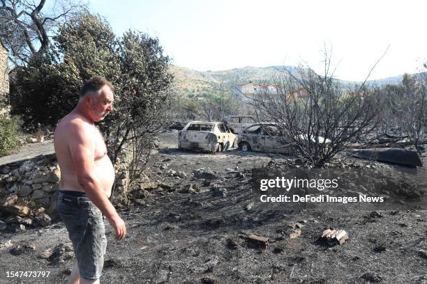 Resident looks at the fire damage after a forest fire swept through the village of Grebastica near Sibenik, Croatia on July 14, 2023. A forest fire...