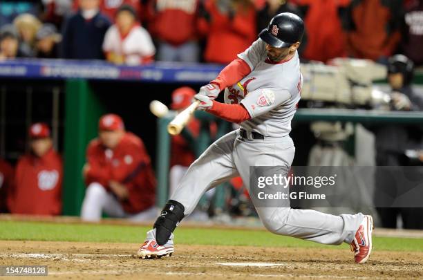 Daniel Descalso of the St. Louis Cardinals hits a home run against the Washington Nationals in Game Five of the National League Division Series at...
