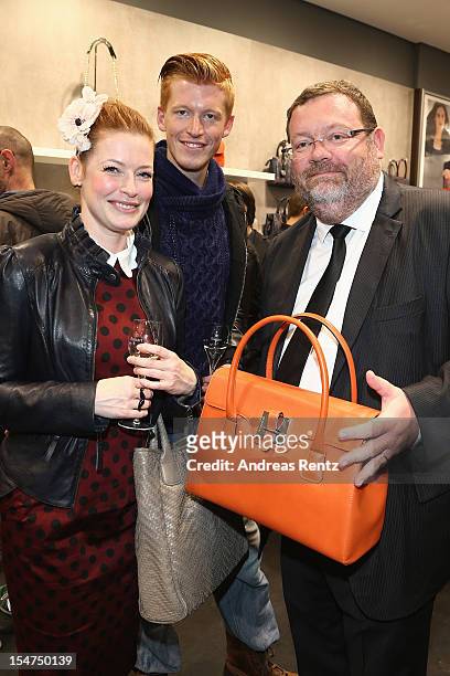 Enie van de Meiklokjes with partner Tobias Staerbo and Gregory Couillard attend the 'Le Tanneur' store opening at Quartier 207 on October 25, 2012 in...