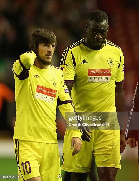 Christopher Samba of FC Anji Makhachkala and Shamil Lahiyalov look dejected at the end of the UEFA Europa League Group A match between Liverpool FC...