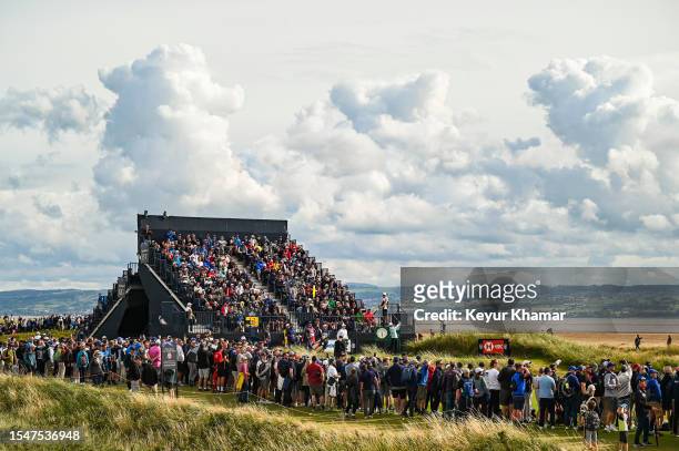Jordan Spieth plays his shot from the 12th tee near the Rolex clock as fans watch from the grandstand during the second round of The 151st Open...