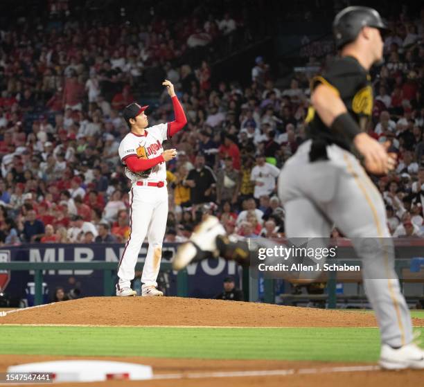 Anaheim, CA Angels star starting pitcher, two-way player and designated hitter Shohei Ohtani stretches his arm after giving up a home run to Pirates...