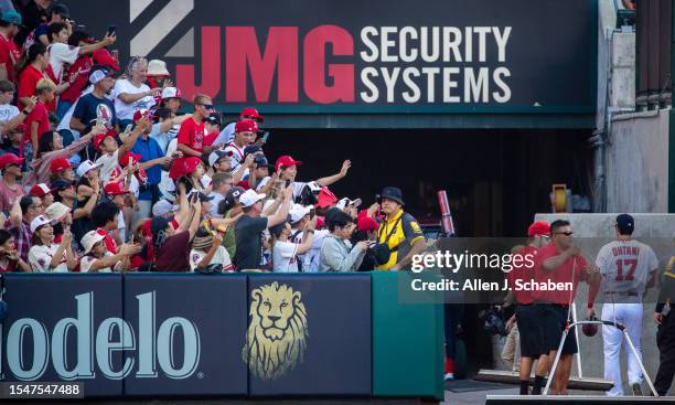 Anaheim, CA Fans cheer as Angels starting pitcher, two-way player and designated hitter Shohei Ohtani heads to warms up in the bull pen during a game...