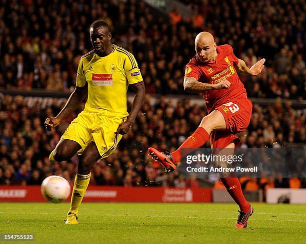 Jonjo Shelvey of Liverpool shoots past Christopher Samba of Anzhi compete during the UEFA Europa League group stage match between Liverpool and FC...