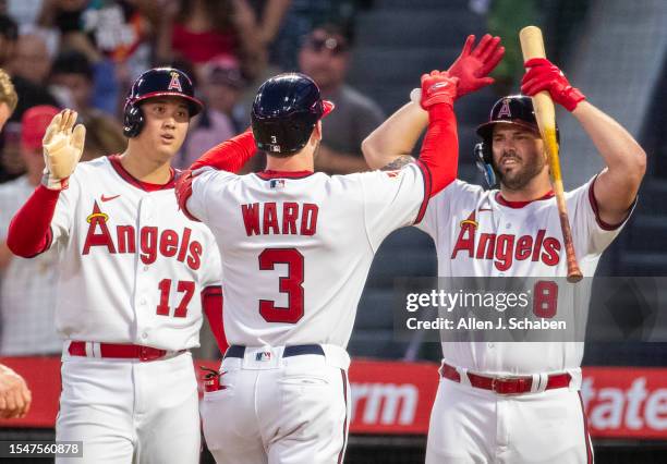 Anaheim, CA Angels starting pitcher, two-way player and designated hitter Shohei Ohtani, left, who scored, and third baseman Mike Moustakas, right,...