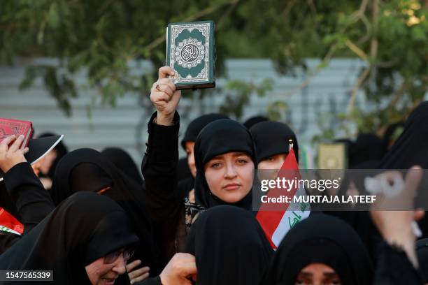 Supporters of Iraq's Hashed al-Shaabi group take part in a protest denouncing the burning in Sweden of the Koran, Islam's holy book, in al-Jadiriyah...