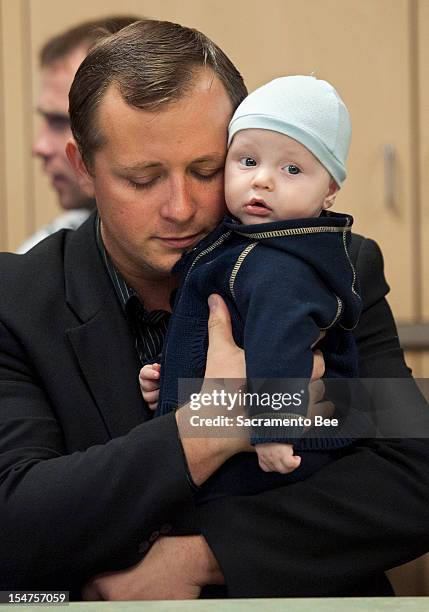 Denis Bukhantsov, the husband of Alina Bukhantsov who was brutally killed in their home along with their children, Emmanuela and Avenir holds his...