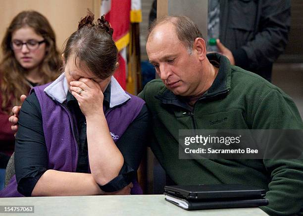 Nadezhda Oliferchik is comforted by her husband Vyacheslav on Thursday, October 25 in Sacramento, California, as they attend a press conference for...