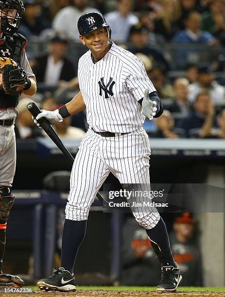 Alex Rodriguez of the New York Yankees reacts after striking out during Game Three of the American League Division Series against the Baltimore...