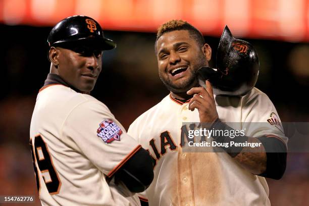 First base coach Roberto Kelly and Pablo Sandoval of the San Francisco Giants look on against the Detroit Tigers during Game Two of the Major League...