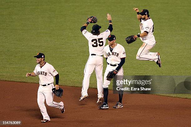 Gregor Blanco, Brandon Crawford, Hunter Pence and Angel Pagan of the San Francisco Giants celebrate after they won 2-0 against the Detroit Tigers...