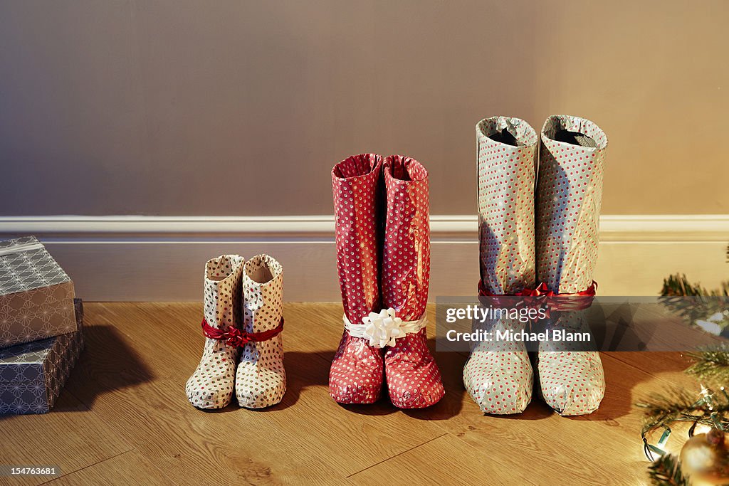 Various sized boots wrapped as christmas presents