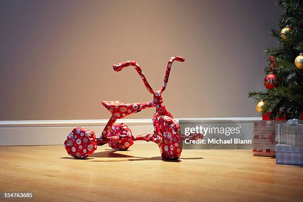 child's bicycle wrapped as a present for christmas - christmas surprise stock pictures, royalty-free photos & images
