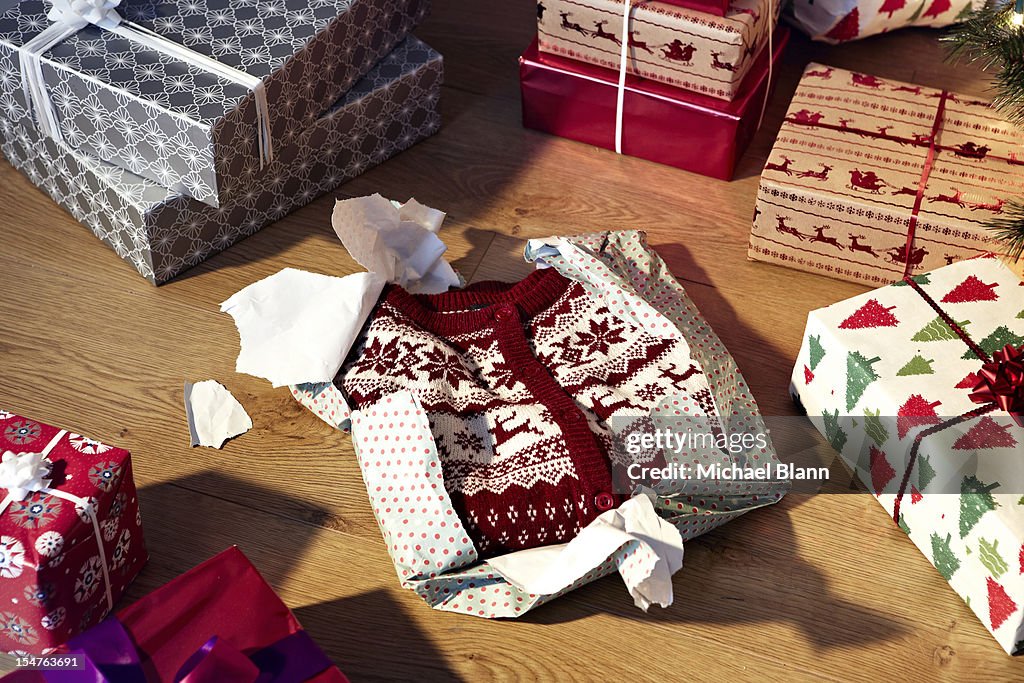 Unwrapped christmas jumper and gifts