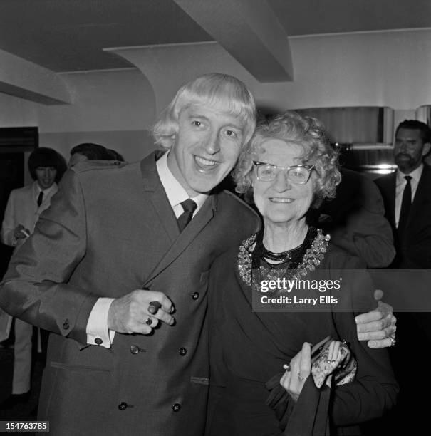 English dj and television presenter Jimmy Savile with his mother, Agnes, at a Variety Club lunch, London, 14th September 1965.