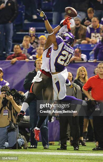 Nate Byham of the Tampa Bay Buccaneers attempts the catch while Josh Robinson of the Minnesota Vikings applies pressure at the Hubert H. Humphrey...