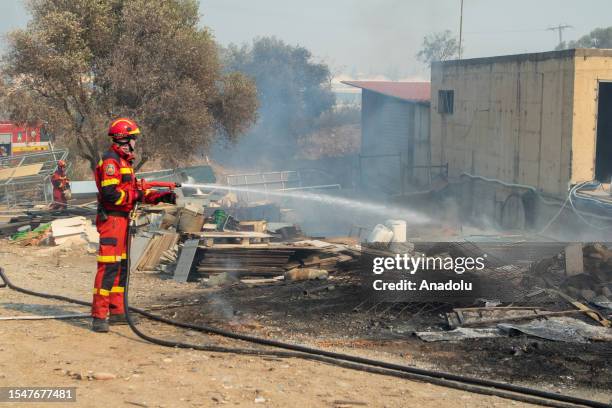 Firefighter teams intervene a wildfire across Greece's Rhodes island on July 22, 2023. Thousands of tourists were evacuated from hotels on the...