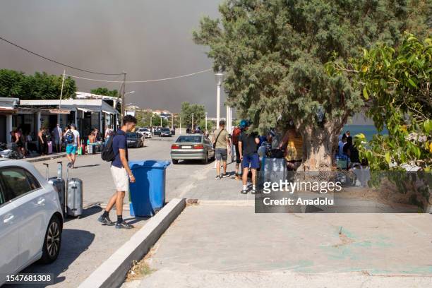 Tourists are evacuated as huge wildfire rages across Greece's Rhodes island on July 22, 2023. Thousands of tourists were evacuated from hotels on the...