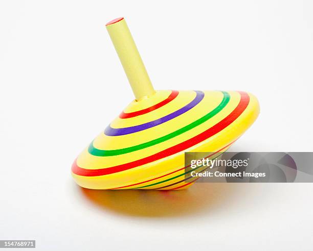 yellow spinning top - trottola foto e immagini stock