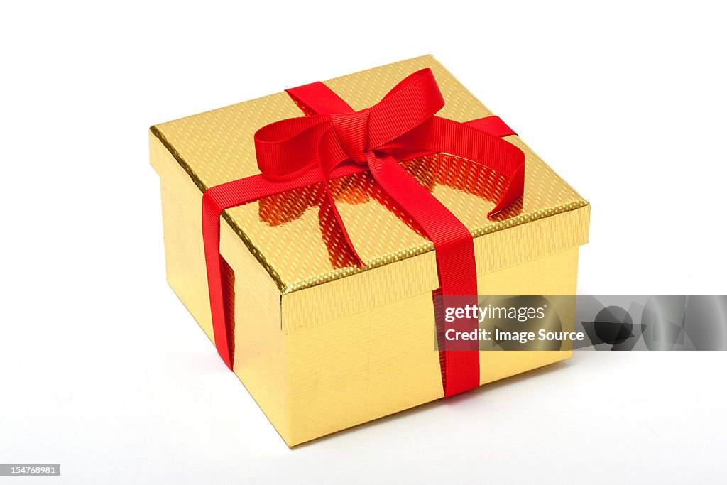 Golden gift box with red ribbon