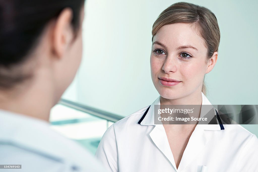 Nurse listening to colleague