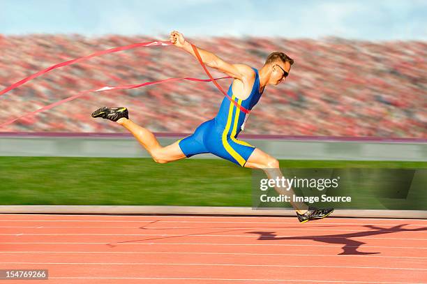 runner crossing the finish line - sprint finish stock pictures, royalty-free photos & images